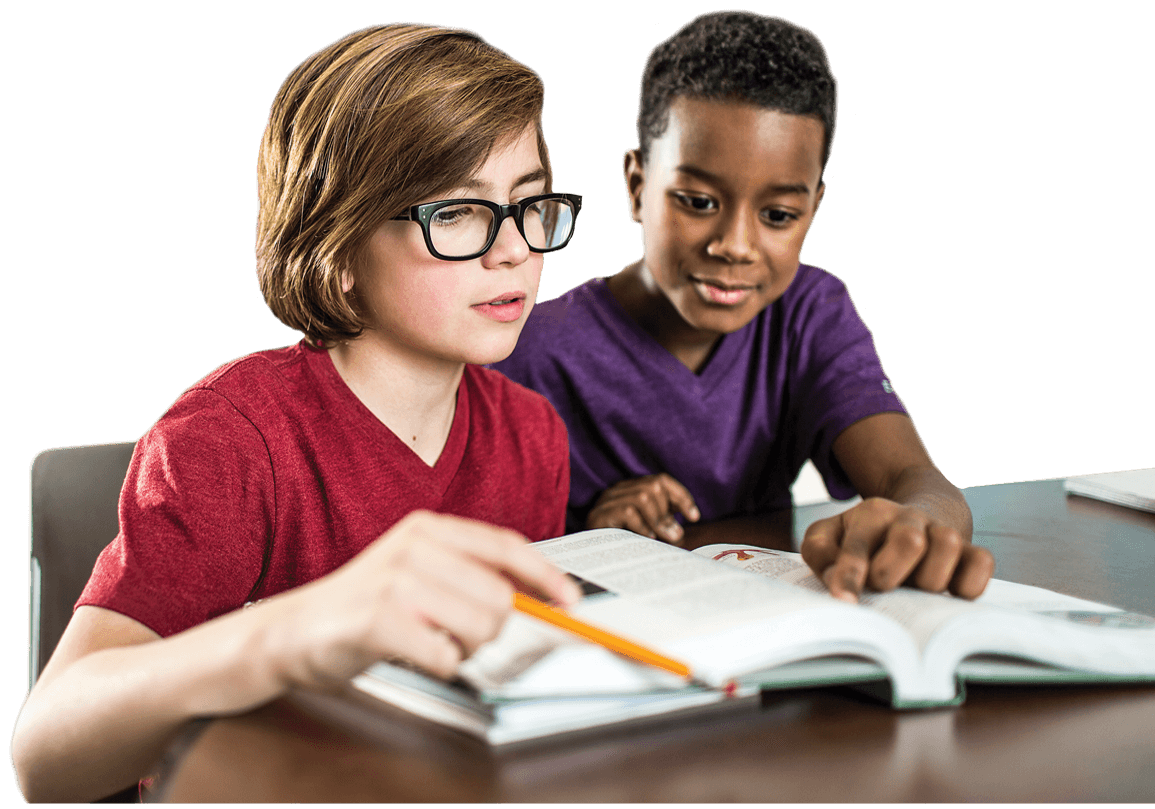 Black boy in purple T-shirt and white boy in red T-shirt and glasses sitting at a table studying a book
