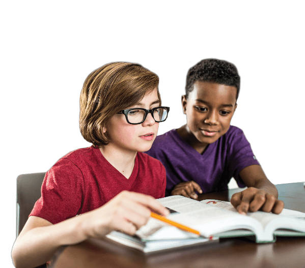 Black boy in purple T-shirt and white boy in red T-shirt and glasses sitting at a table studying a book