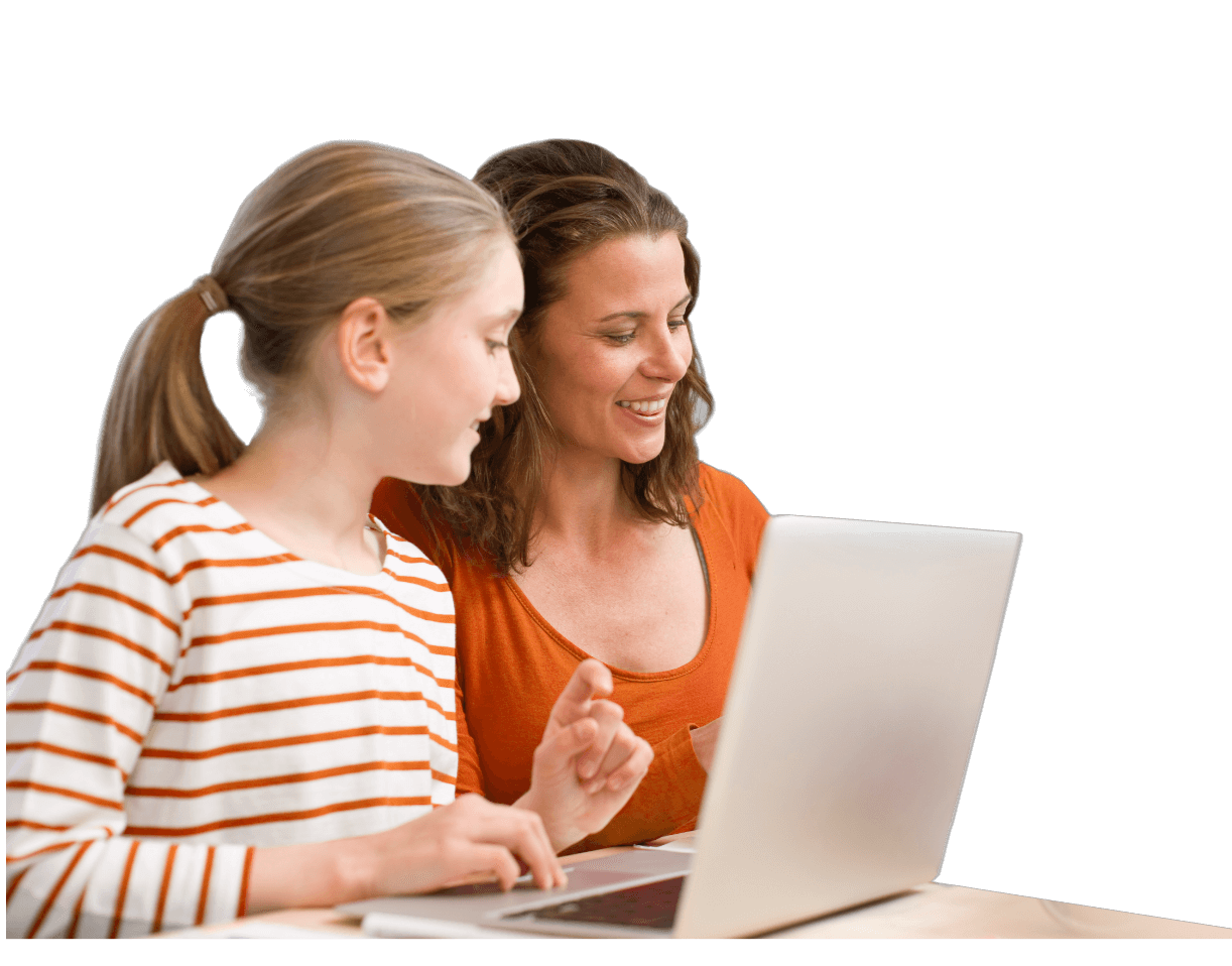 Smiling woman and girl sitting at a table looking at a laptop