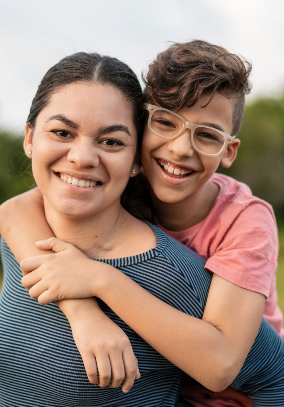 Photograph of a boy hugging a woman